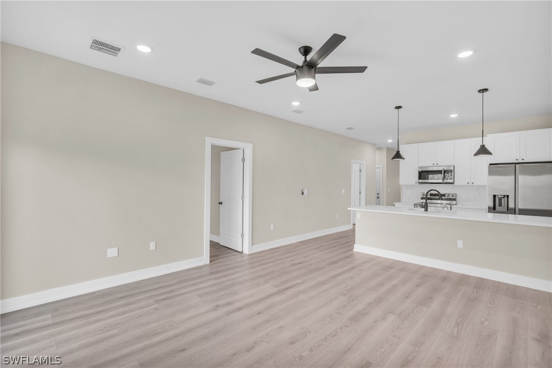 12208 Tetzel Avenue Port Charlotte, FL 33981 - Photo 9 of 45 a view of a kitchen with a sink and wooden floor