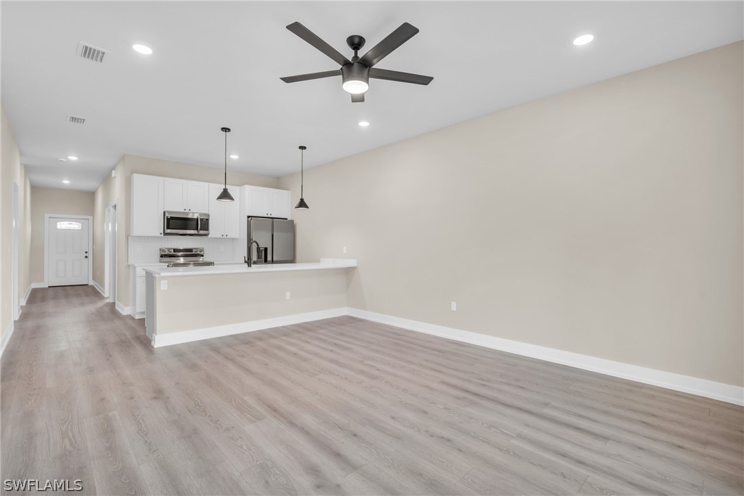 12208 Tetzel Avenue Port Charlotte, FL 33981 - Photo 10 of 45 a view of kitchen with cabinets and wooden floor