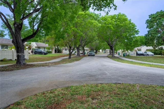 a view of a house with a yard and tree s