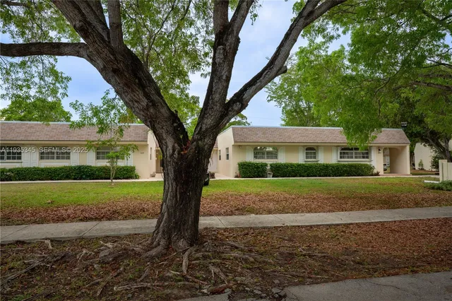 a view of a house with a yard and plants