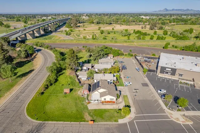 a view of a patio with table and chairs potted plants