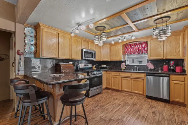 a living room with furniture a flat screen tv and a large window