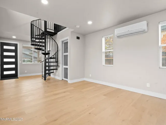 an empty room with windows and stairs