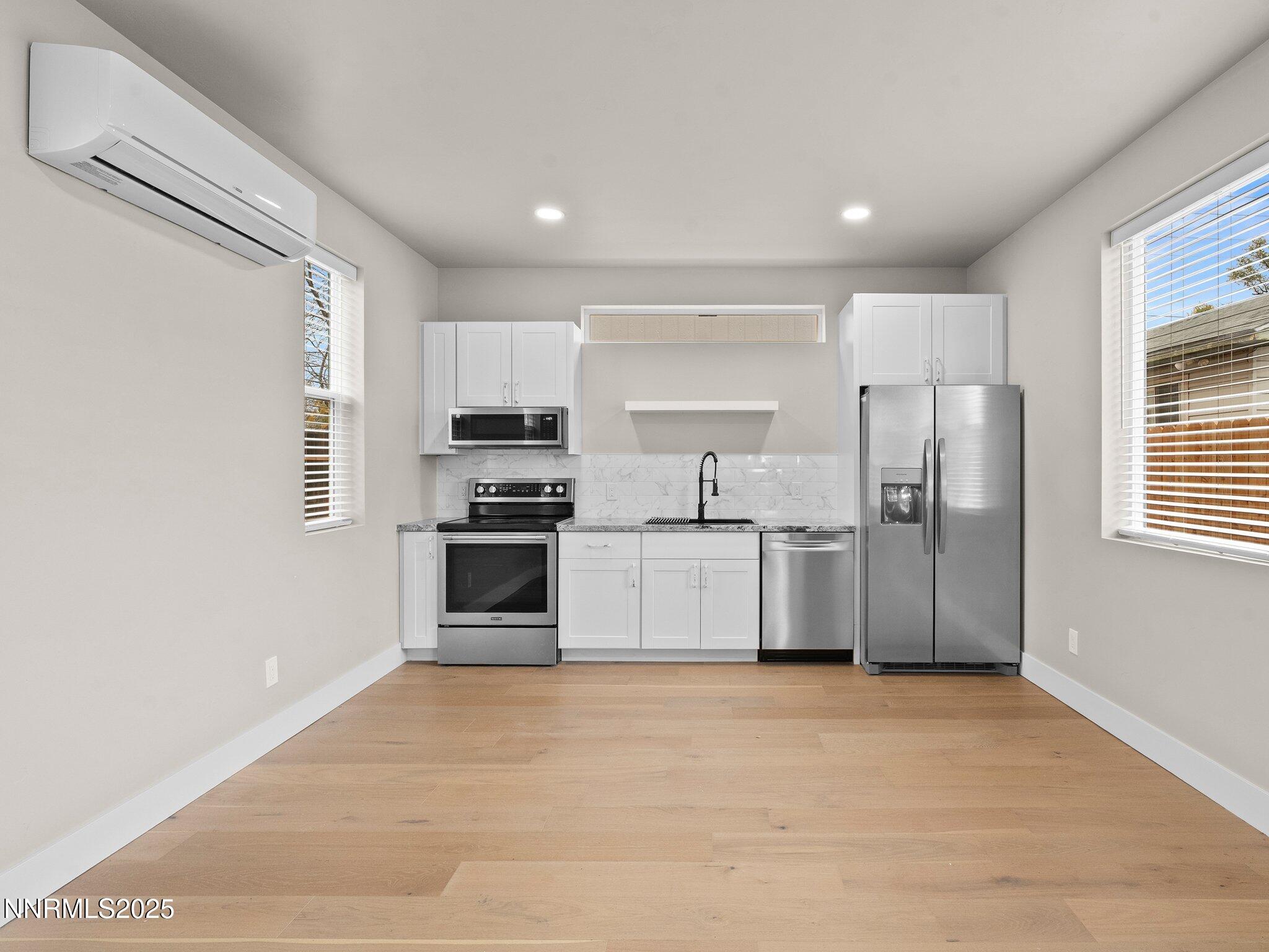 1844 H Street, Unit 1 Sparks, NV 89431 - Photo 6 of 14 a kitchen with stainless steel appliances a refrigerator sink and cabinets