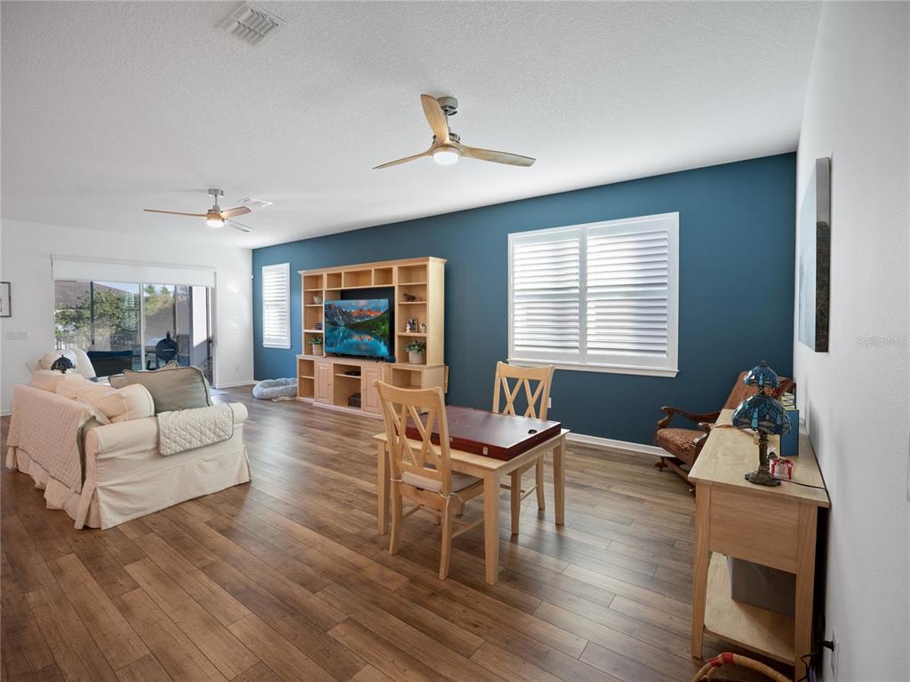 8741 Southwest 61st Loop Ocala, FL 34481 - Photo 11 of 60 a living room with furniture a window and a flat screen tv