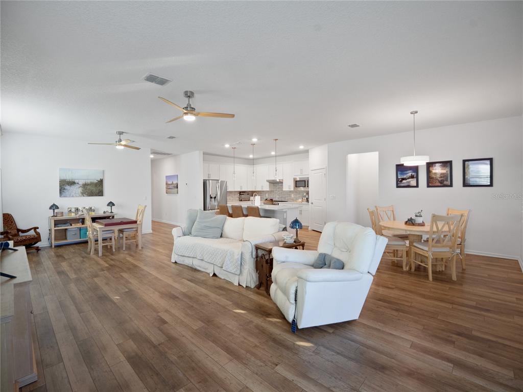 8741 Southwest 61st Loop Ocala, FL 34481 - Photo 14 of 60 a living room with furniture and a wooden floor