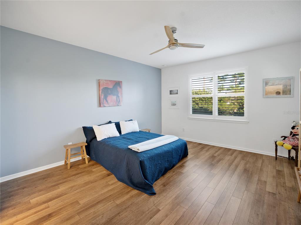 8741 Southwest 61st Loop Ocala, FL 34481 - Photo 18 of 60 a living room with a bed furniture and a window