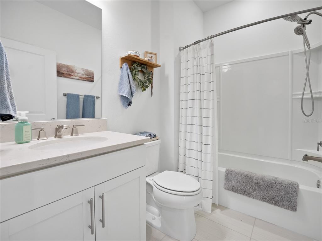 8741 Southwest 61st Loop Ocala, FL 34481 - Photo 25 of 60 a bathroom with a sink a toilet and shower