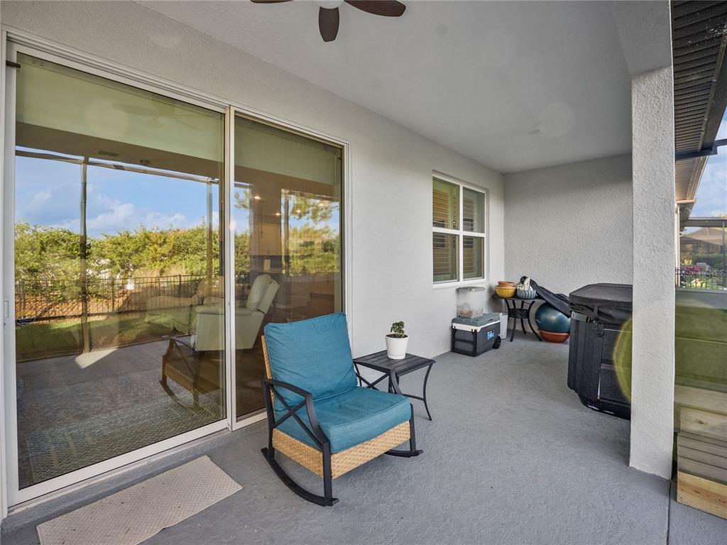 8741 Southwest 61st Loop Ocala, FL 34481 - Photo 31 of 60 a living room with furniture and a floor to ceiling window