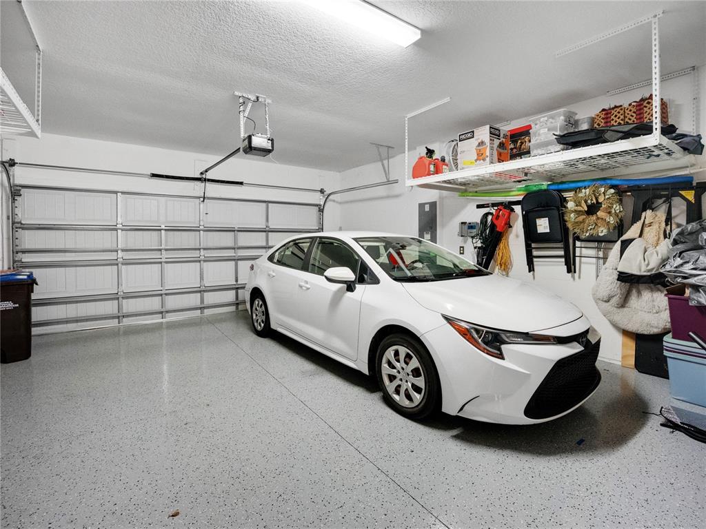 8741 Southwest 61st Loop Ocala, FL 34481 - Photo 34 of 60 a car and bike parked in a garage