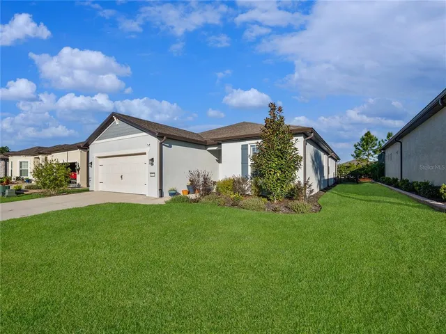a view of a front of a house with a yard and garage