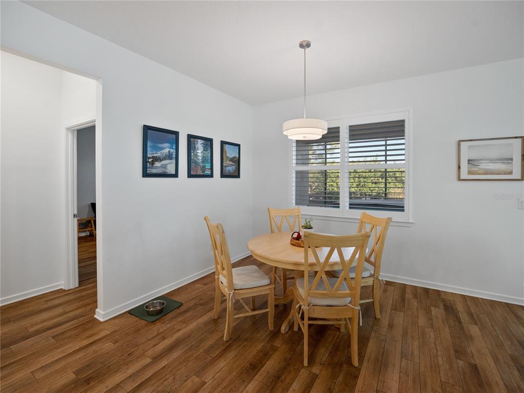 8741 Southwest 61st Loop Ocala, FL 34481 - Photo 4 of 60 a view of a dining room with furniture window and wooden floor