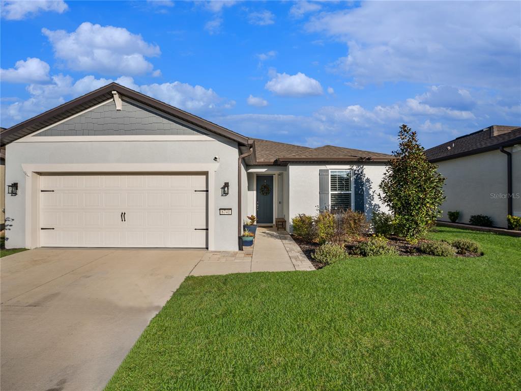 8741 Southwest 61st Loop Ocala, FL 34481 - Photo 41 of 60 a view of a front of a house with a yard and garage