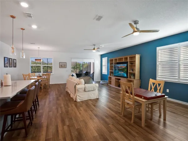 a living room with furniture a window and a flat screen tv