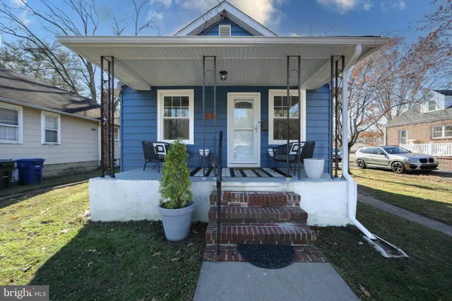 a view of a house with backyard sitting area and tub