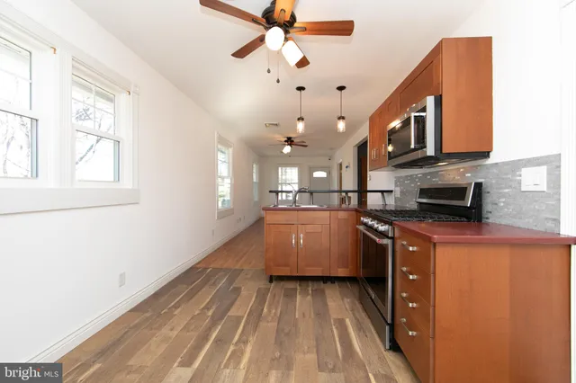 a kitchen with cabinets a sink and appliances