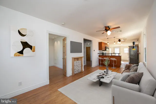 a living room with furniture and a kitchen view