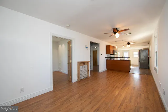 a view of a kitchen with a sink a refrigerator and a stove top oven