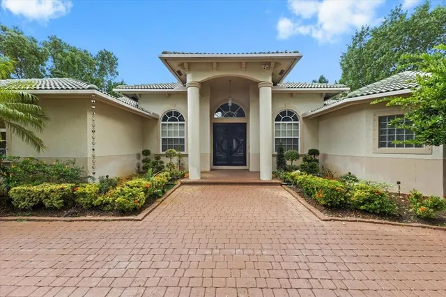 front view of a house with potted plants