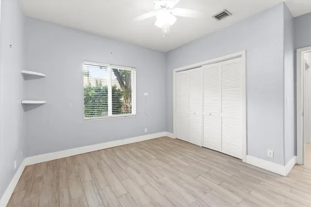 a bathroom with a sink a toilet a large mirror and shower