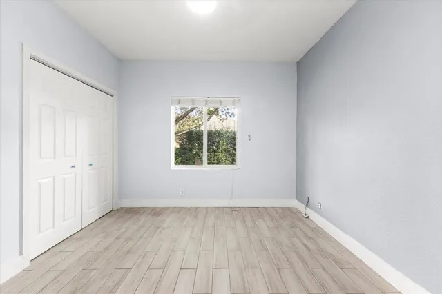 wooden floor in an empty room with a window