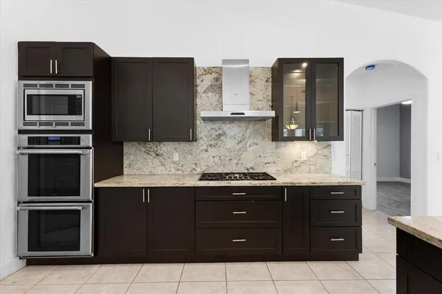 a kitchen with granite countertop stainless steel appliances and cabinets