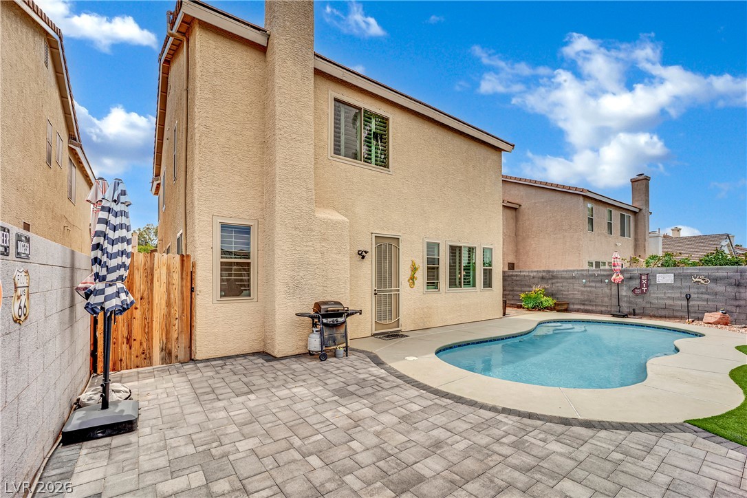 1724 Millstream Way Henderson, NV 89074 - Photo 34 of 60 An inviting backyard features a private swimming pool, perfect for outdoor recreation and relaxation.