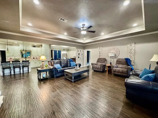 a living room with furniture and wooden floor