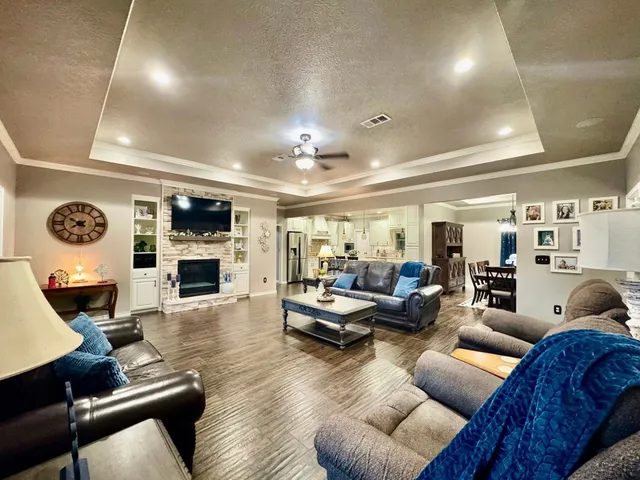 a living room with furniture a fireplace and a flat screen tv