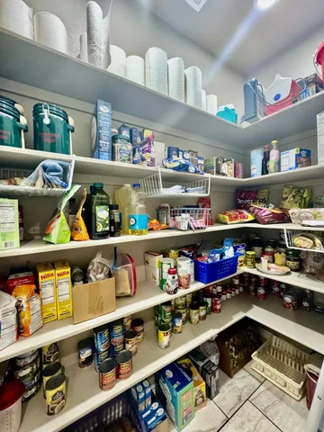 a kitchen with lots of clutter and cabinets