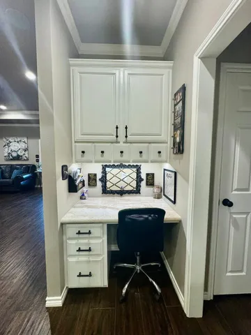 a view of cabinets a wooden floor and a window
