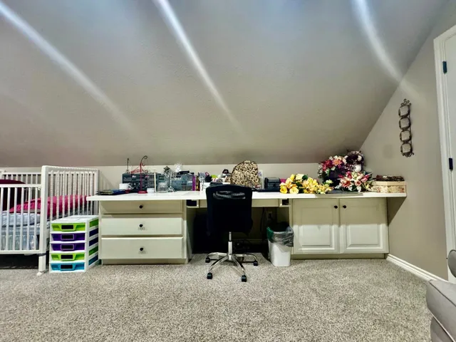 a room with gym equipment and large windows