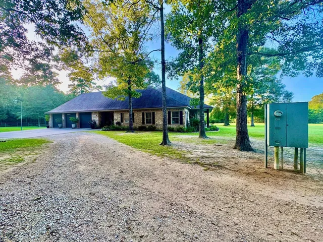 a house with swimming pool in front of it