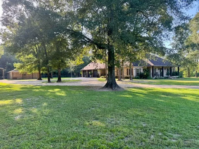 a swimming pool with outdoor seating and yard
