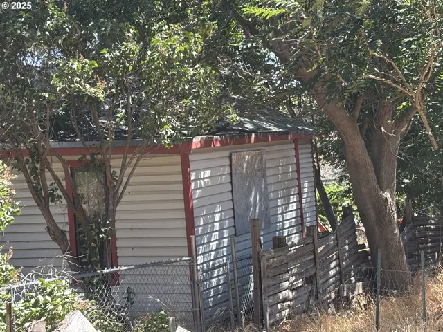 a view of a wooden balcony and trees