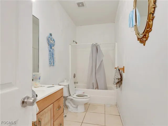 a bathroom with a sink mirror and toilet