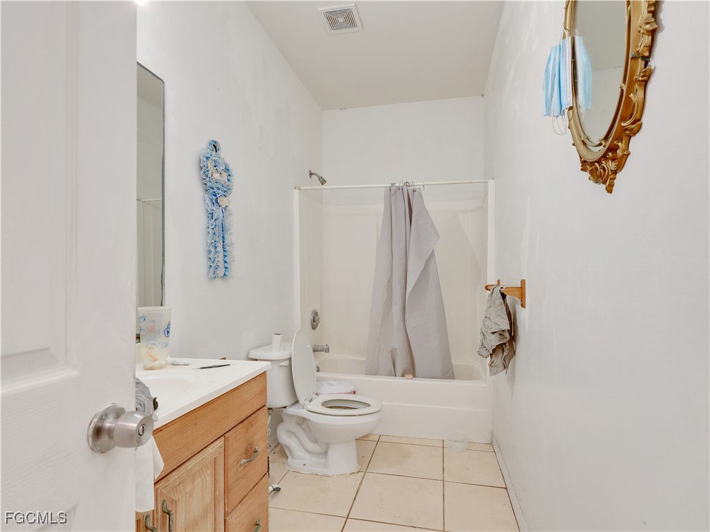 4639 19th Place Southwest Naples, FL 34116 - Photo 4 of 6 a bathroom with a sink mirror and toilet