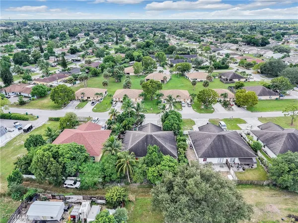 an aerial view of residential houses with outdoor space and street view