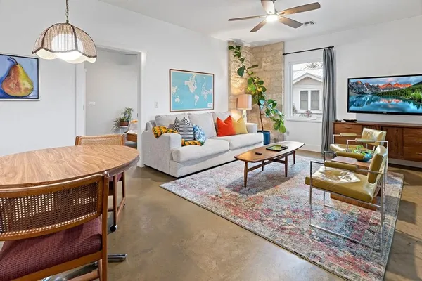 a living room with furniture and wooden floor