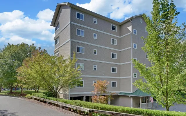 a front view of a building with trees