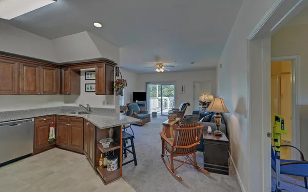 a view of a livingroom with furniture and a kitchen
