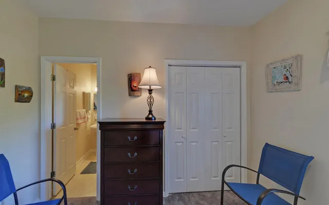 a room with a chair and mirror