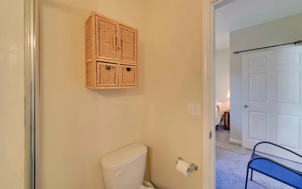 a bathroom with a toilet and a shower