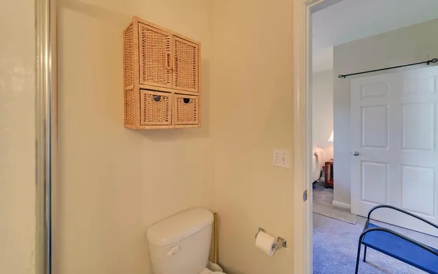 a bathroom with a toilet and a shower