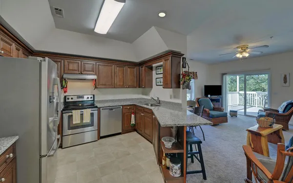 a kitchen with sink refrigerator and window