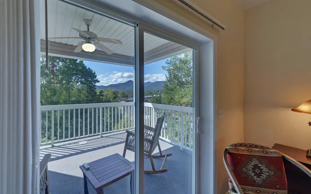 a view of a dining room with furniture wooden floor and fan