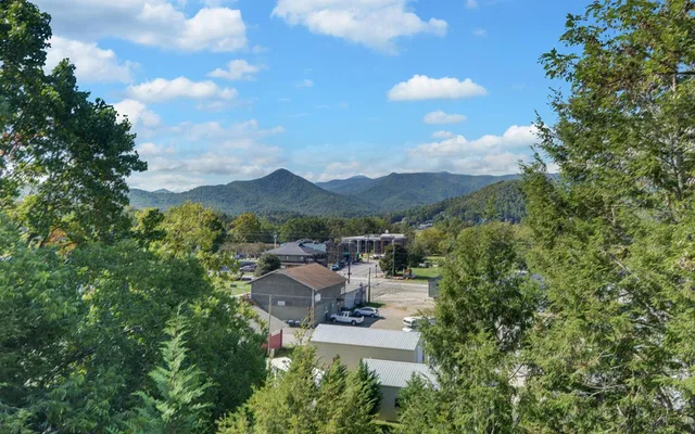 a view of a patio with dining table and chairs