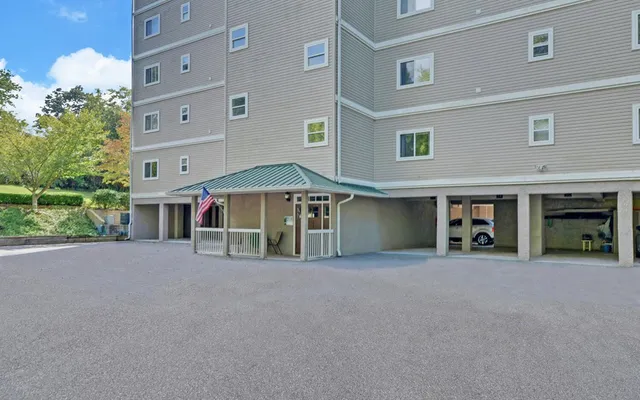 a view of a house with a yard and garage