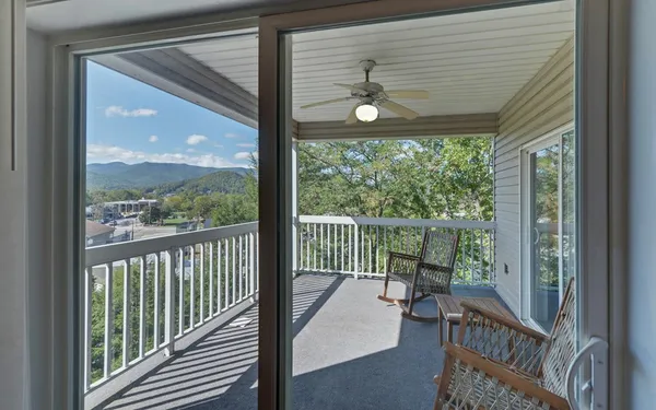 a view of a porch with furniture and wooden deck
