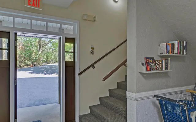 a view of entryway and hall with wooden floor